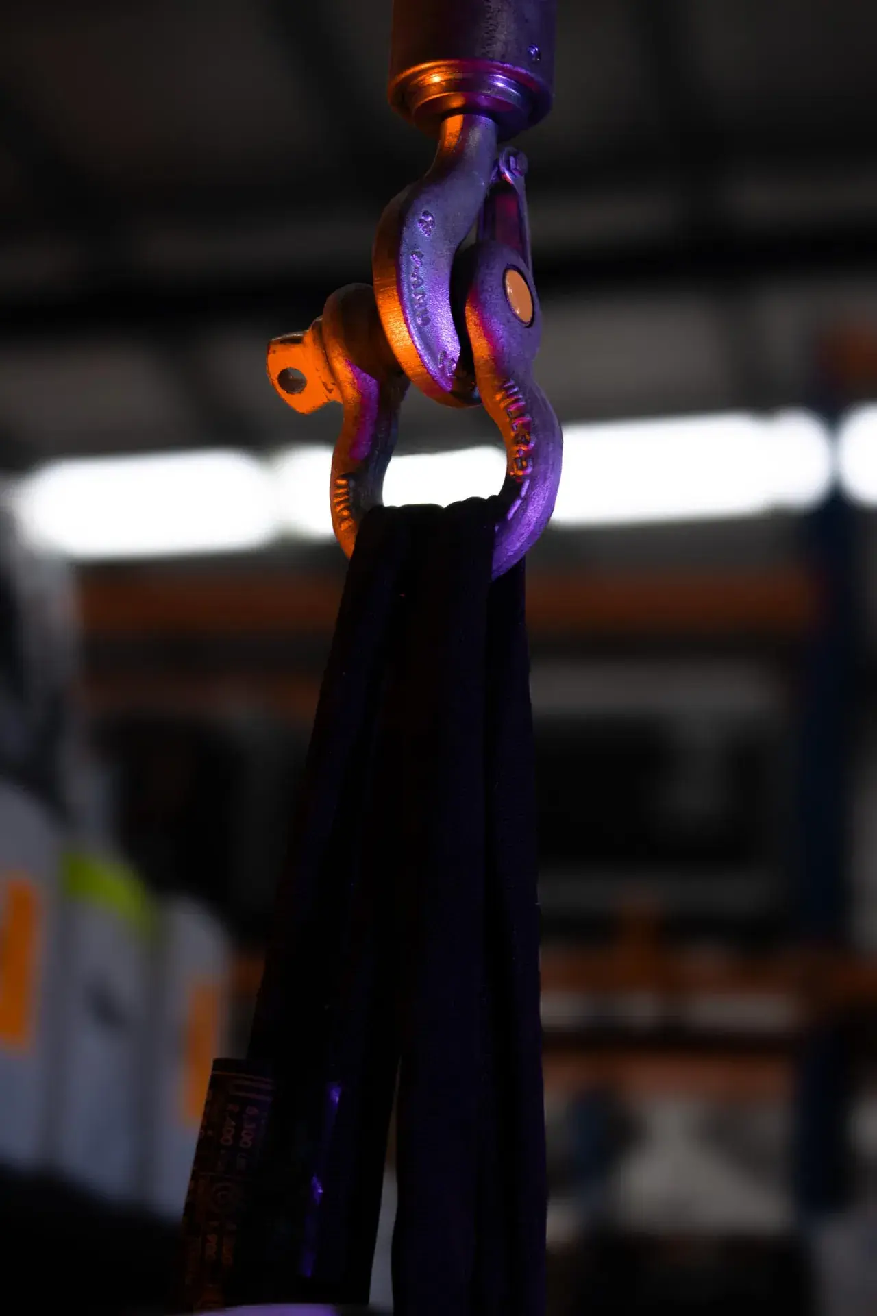Close detail of a soft steel round sling eye and jacket - the wear surfaces a competent person checks at every 12-month inspection.