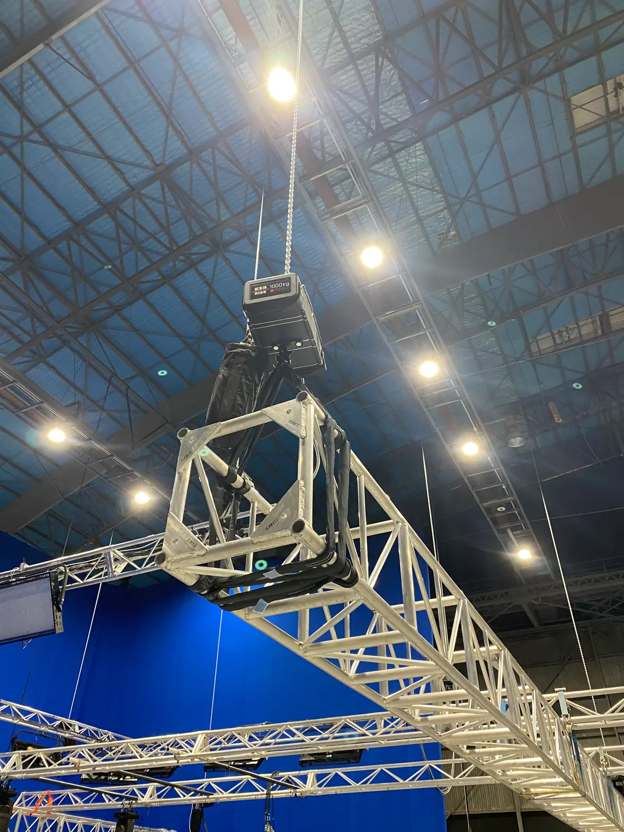 Chain hoist and aluminium truss above a blue-screen film studio set
