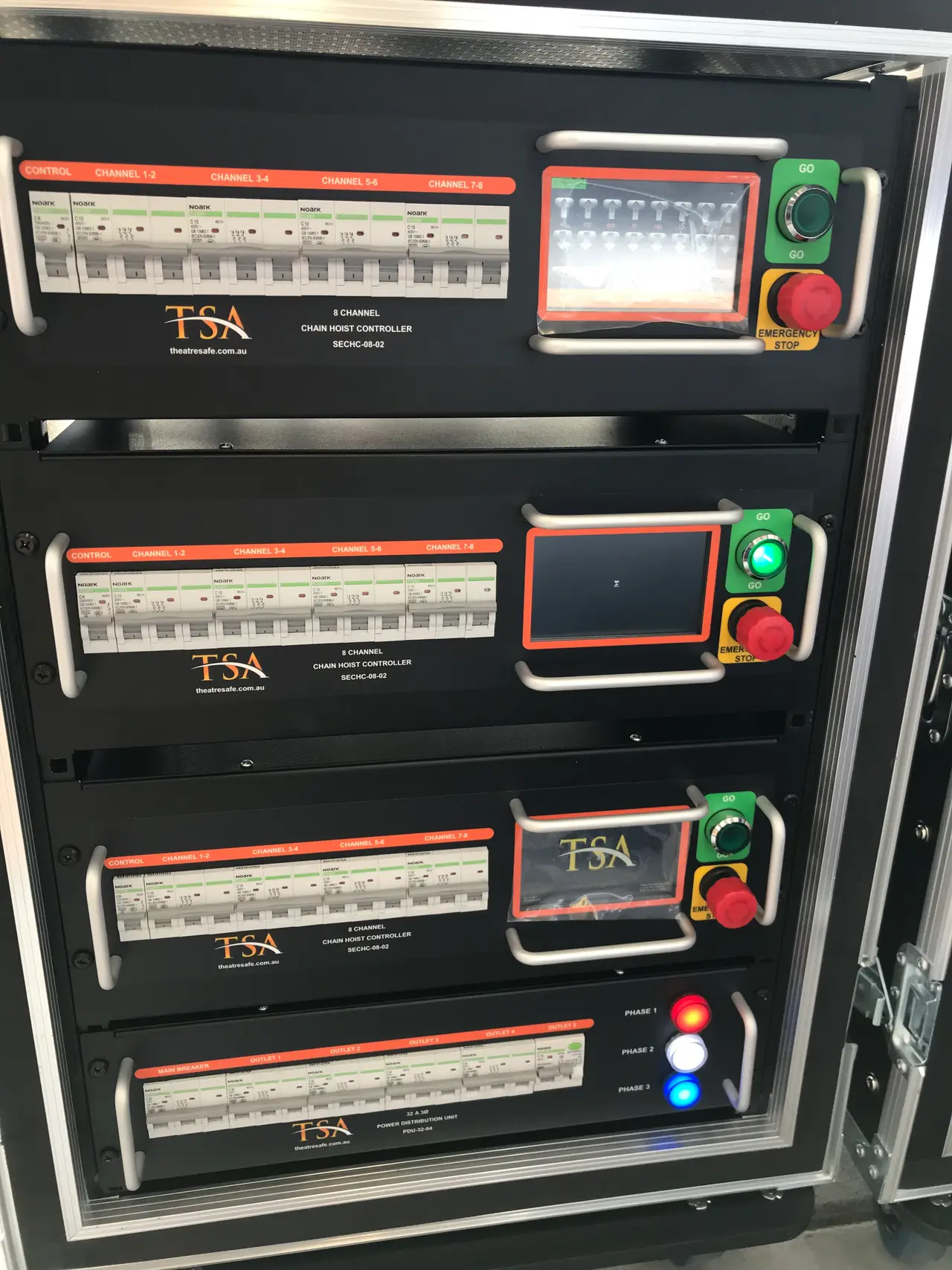 Three TSA 8-channel chain hoist controllers and a power distribution unit stacked in one rack case.