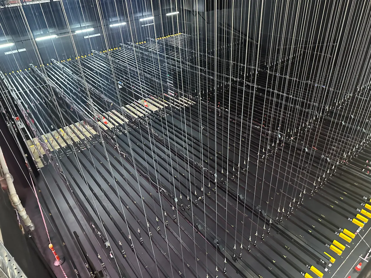 Looking down on numbered fly lines and battens in a counterweight fly tower.