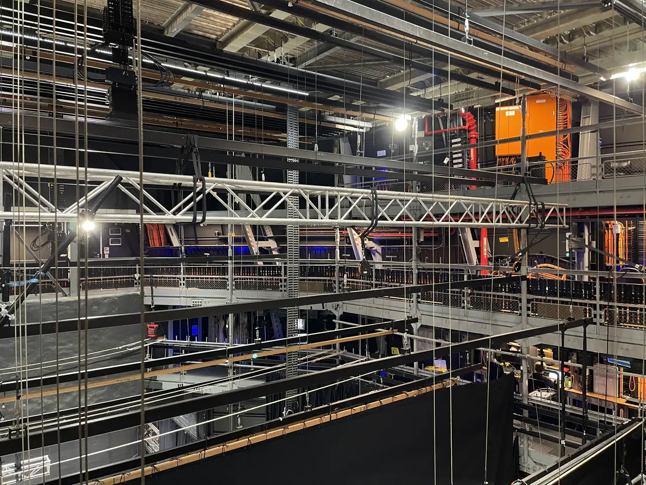 Inside the Sydney Opera House fly tower, with rigged truss, ladders and an electrical cabinet.