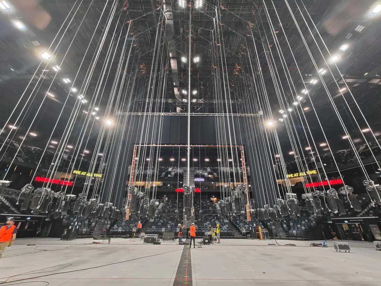Hundreds of chain hoists fan out overhead in a dramatic array at Etihad Arena