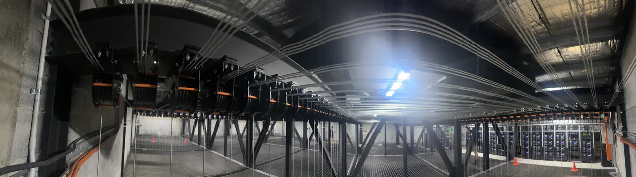 Panoramic view of an entire row of loft block pulleys spanning the fly tower grid.