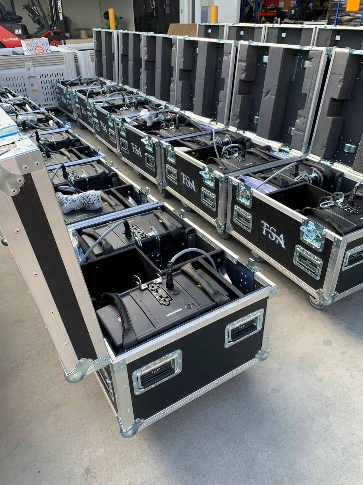 Wide warehouse view of chain hoist hire fleet cases staged for dispatch