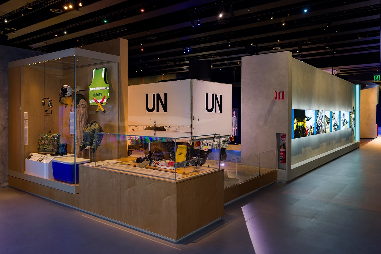 Timber and glass showcase with UN supply crates and aid worker equipment