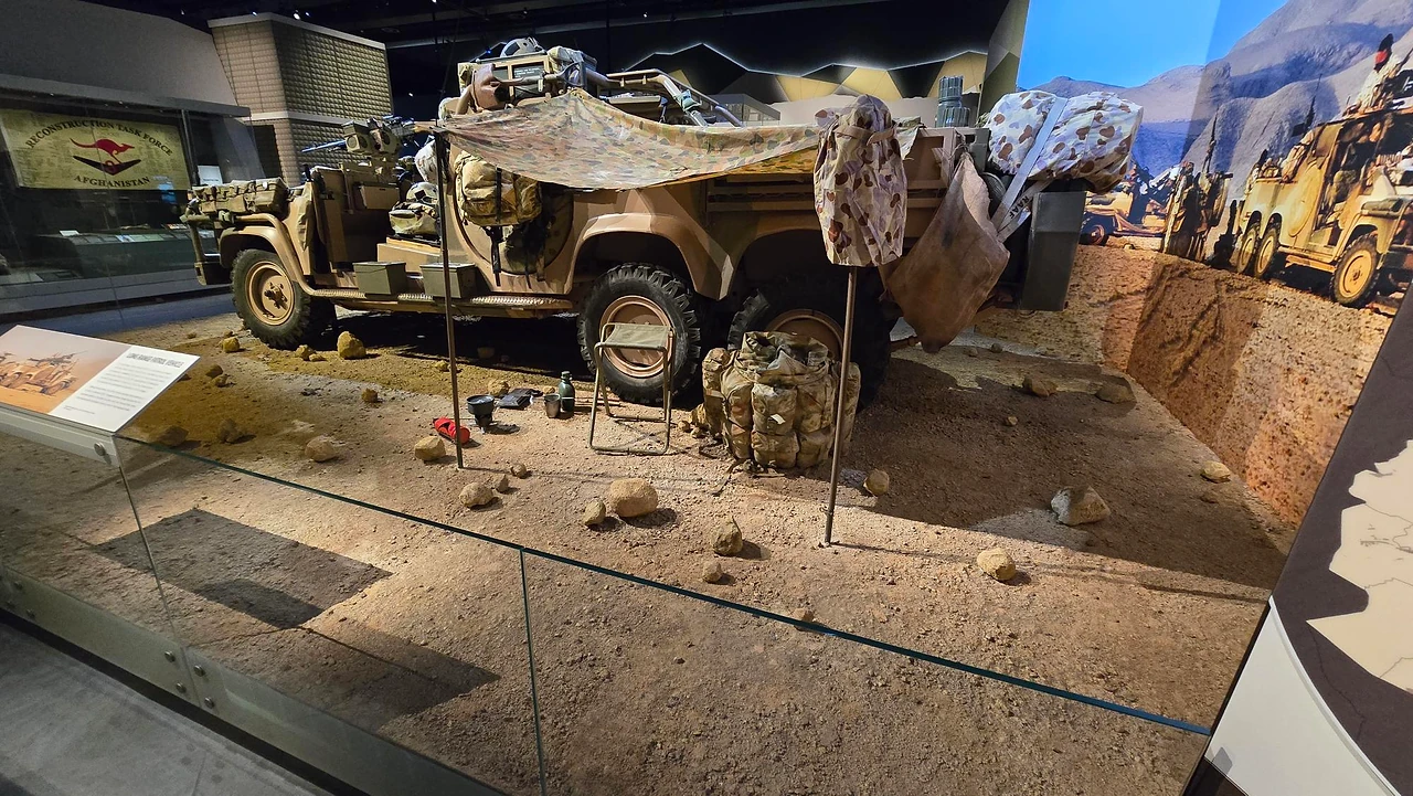 Fabricated desert diorama with a patrol vehicle, rocks and a curved printed backdrop