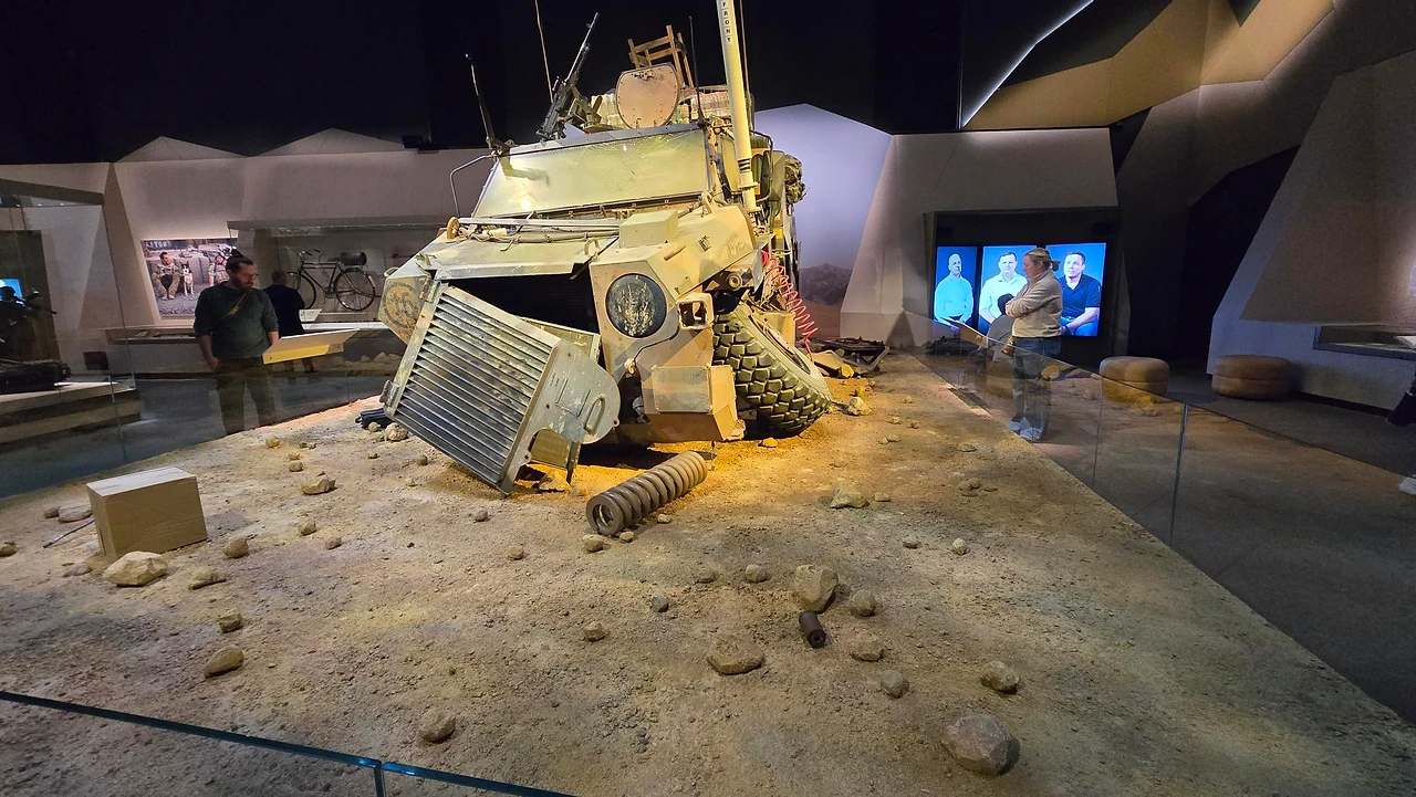 Wrecked armoured vehicle on a sculpted desert base behind a glass edge