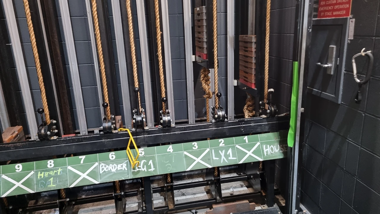 Counterweight arbor guides, manila ropes and rope lock handles above the labelled line board