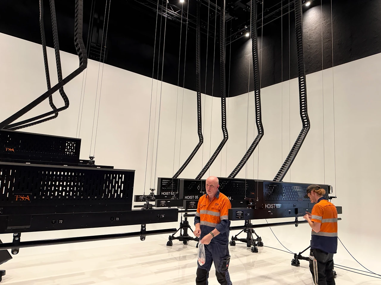 TSA crew working beneath the studio hoist array in a production studio at ECU City Campus.