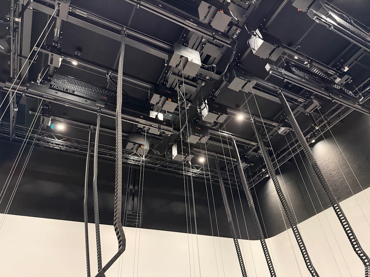 Looking up into the hoist grid and cable chains at ECU City Campus.