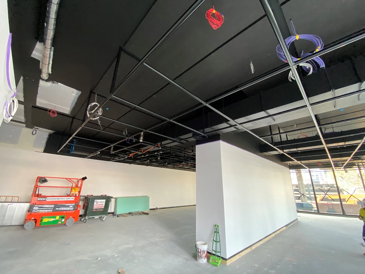 Modular pipe grid sections being installed in University Gallery 1 at ECU City Campus.