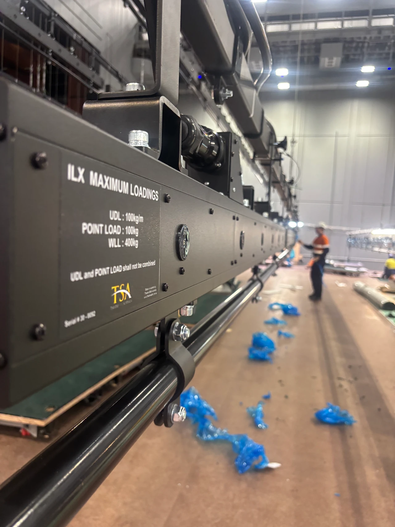 ILX lighting bar with maximum loadings label hanging above the stage floor
