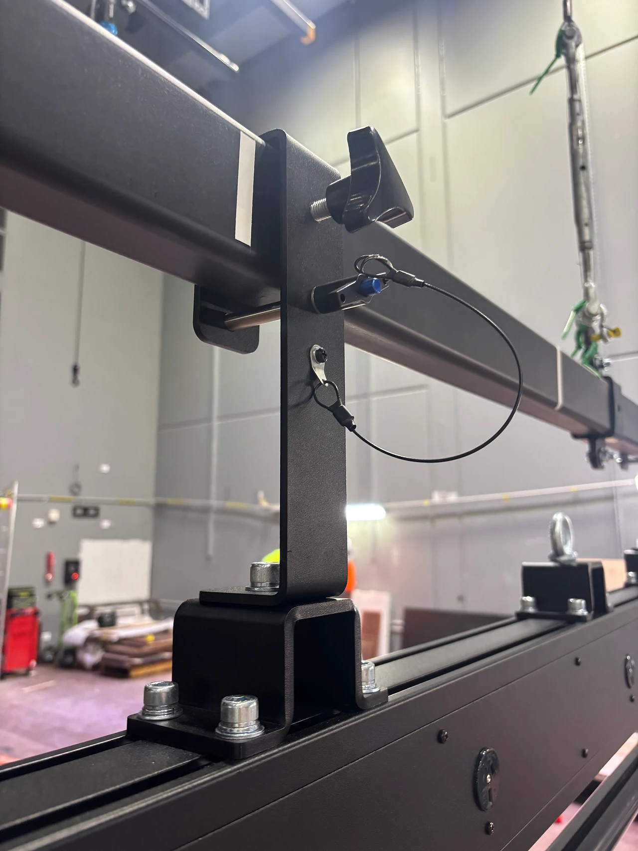 Close view of a lighting bar bracket and mounting post with a cable loop