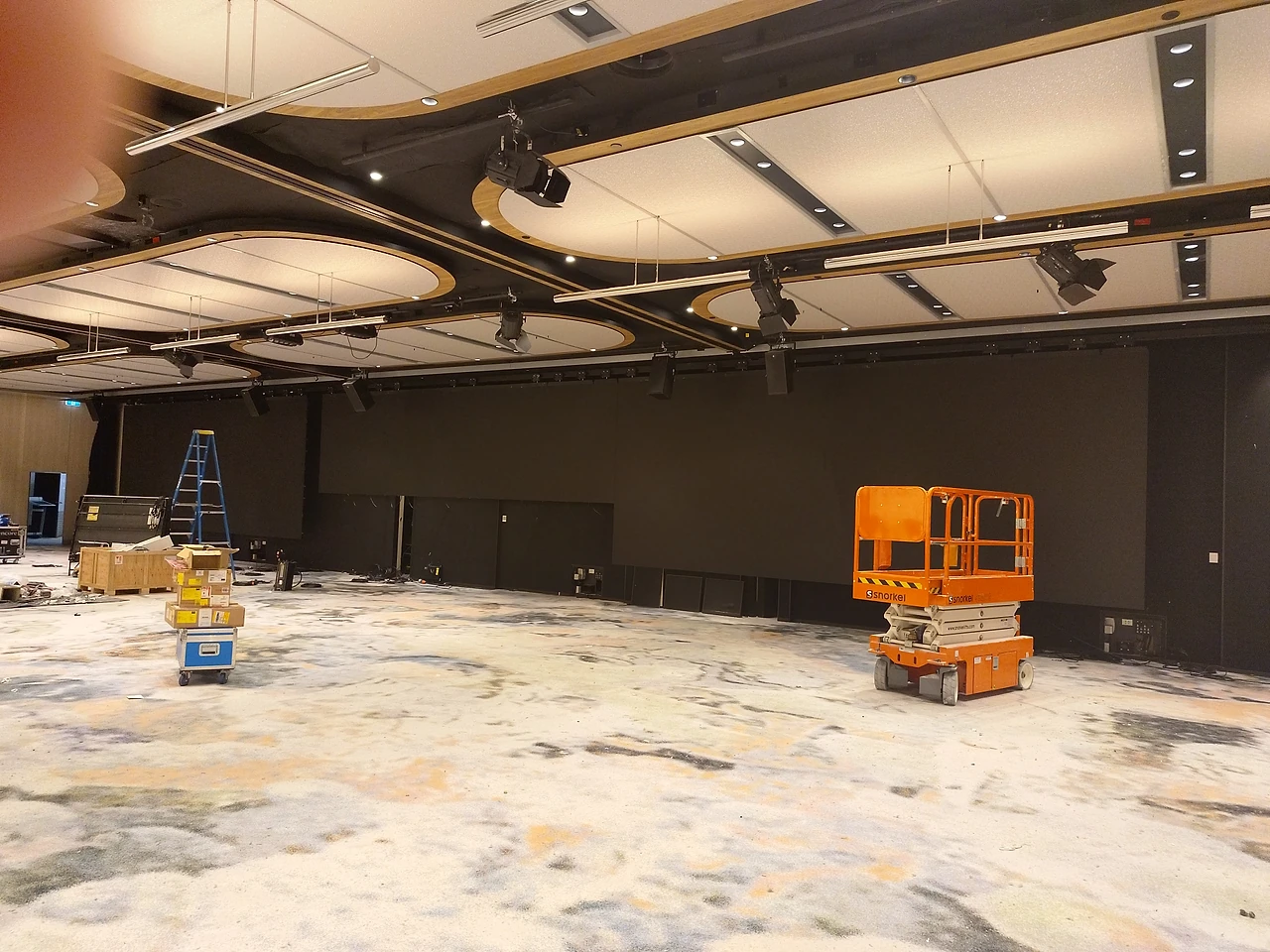 Installation underway in the Golden Ballroom at the Pan Pacific, with a scissor lift below the new ceiling rigging.