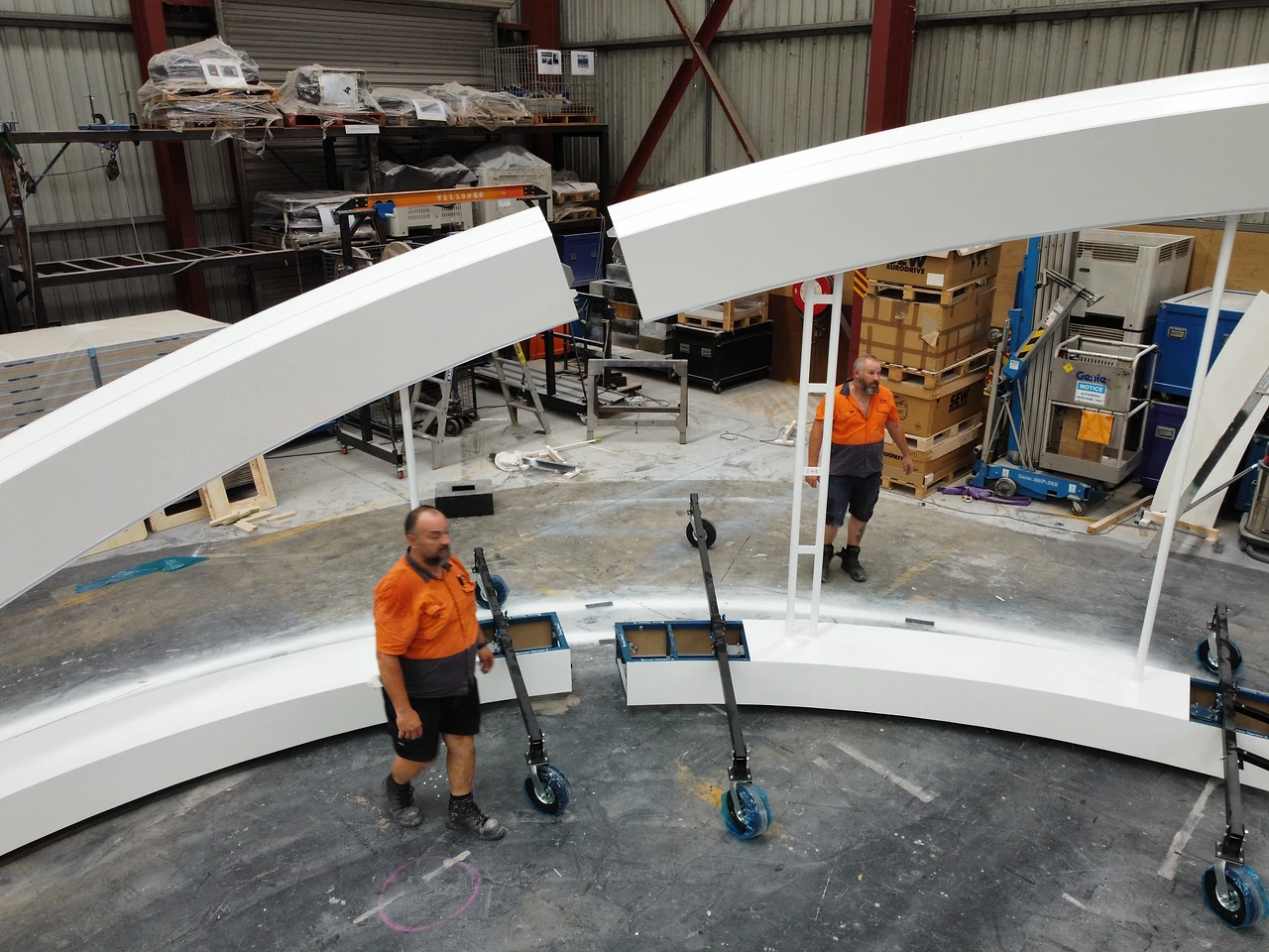 Two arch segments meeting at the join, lifted into position by hand and dolly