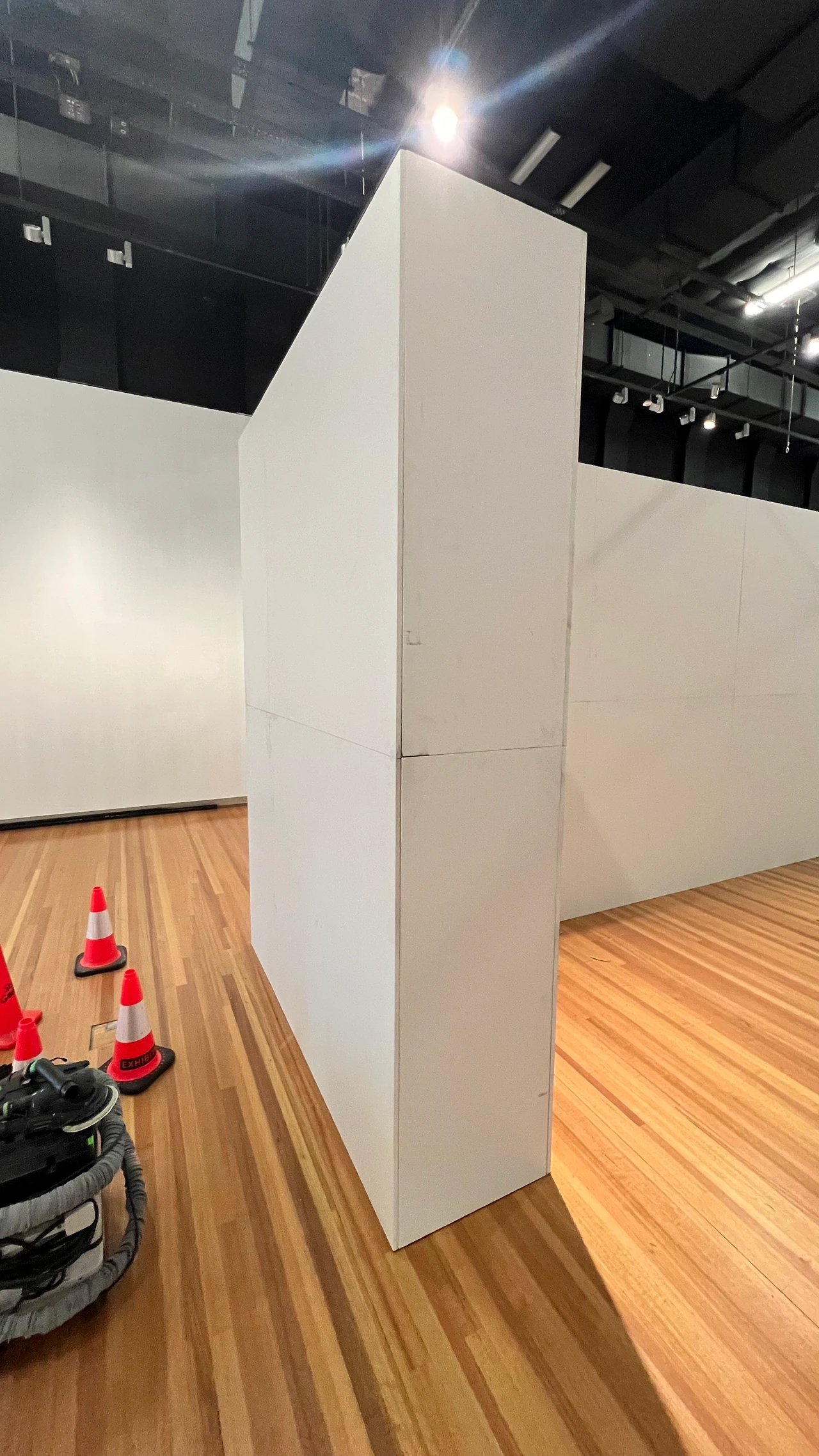 Edge of the modular wall panel standing in the gallery with traffic cones on the timber floor. Design: Tim Blaikie, TSA. Photo: TSA.