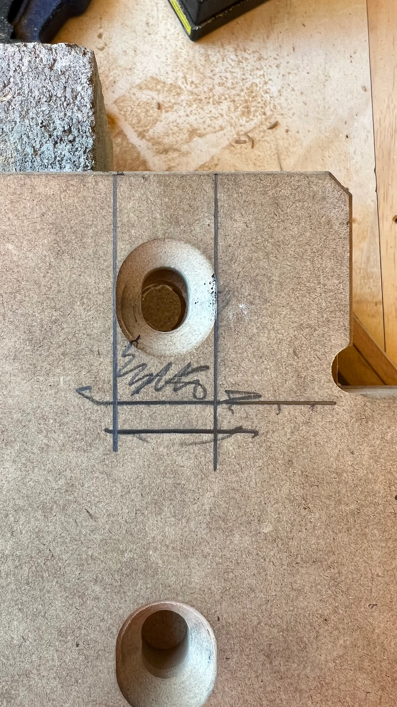 Close view of a routed MDF template with countersunk holes and marked centre lines used to set out the wall fixings. Design: Tim Blaikie, TSA. Photo: TSA.