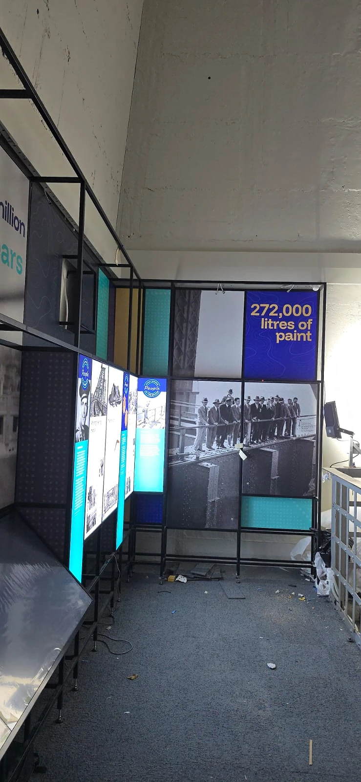 Run of illuminated display panels with colour-blocked graphics in a pylon room